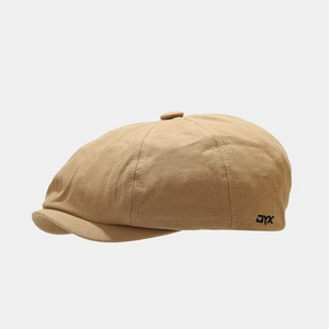Close-up of khaki newsboy cap featuring detailed cotton canvas texture and black JYX embroidery