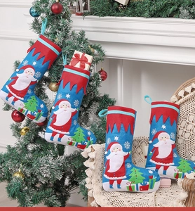 Detail of embroidered Christmas stocking with 3D Santa and gift tree on festive background