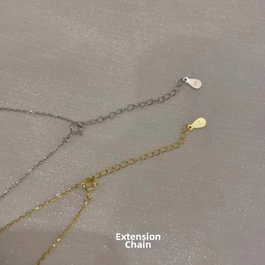 Close-up of S925 sterling silver extension chains in gold and silver with teardrop charms