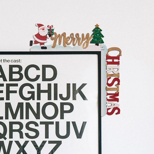 Detail of wooden Merry Christmas corner ornament with Santa Claus and tree on door frame