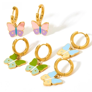 Detail of colorful enamel butterfly charms on gold-plated stainless steel hoop earrings