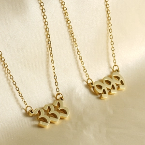 Two 18k gold plated stainless steel necklaces featuring 333 number pendants on beige silk