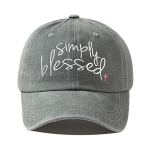 Close-up of Simply Blessed white embroidery and pink cross on washed grey cotton cap