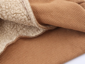 Detail of brown ribbed knit cuff with thick white faux shearling lining for warmth