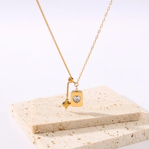 18K gold plated heart cube pendant necklace on a plaster display stand for women