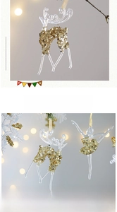 Detail of acrylic Christmas ornaments with gold sequins featuring reindeer and ballet dancer