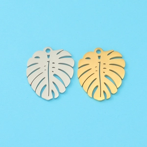 Detailed view of monstera leaf charms in gold and silver finish for DIY jewelry making