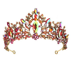 Vintage gold baroque bridal crown with colorful crystals and red gems on white background