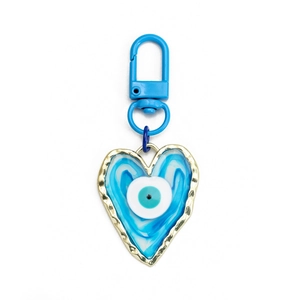Detailed view of heart-shaped evil eye keychain with blue enamel and gold-tone finish