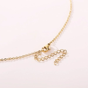 Gold evil eye necklace with adjustable lobster clasp closure and dainty cross chain