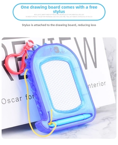 Mini dinosaur magnetic drawing board with stylus and red carabiner on marble surface