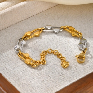 Detailed shot of two-tone heart link bracelet with extension chain and lobster clasp