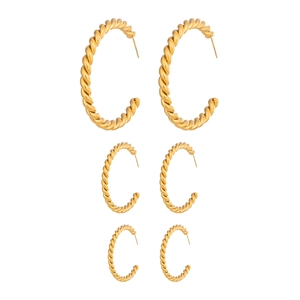 Three pairs of twisted C-shaped gold-plated stainless steel hoop earrings in tiered sizes