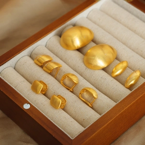 Elegant gold geometric copper earrings set with matte finish and diamonds in wood box