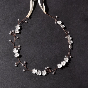 Detail showing golden wire floral wedding headband with white petals and pearls
