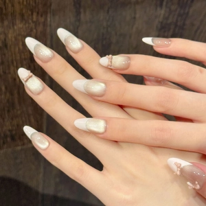 Pink French bow press-on nails with champagne cat-eye shimmer and almond shape