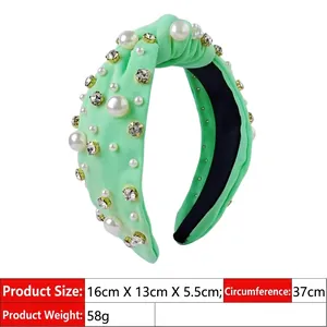 Detail of mint green knotted headband with white pearls and sparkling rhinestones