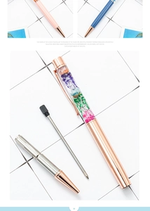 Disassembled view showing the rose gold pen body, internal dried flowers, and ink refill