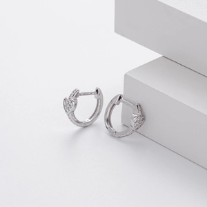Macro shot of S925 sterling silver heart earrings with sparkling cubic zirconia pavé