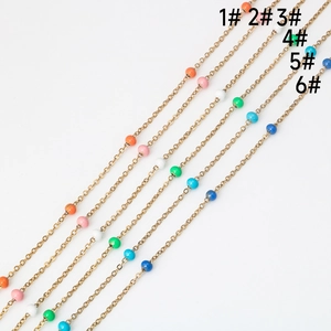 Close-up of handmade gold metal chains with colorful beads in six vibrant color styles