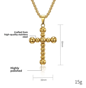 Detailed view of 50mm polished gold steel cross pendant with round bead design