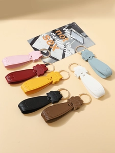 Close-up of cute cat-shaped faux leather keychains in multiple colors with gold rings