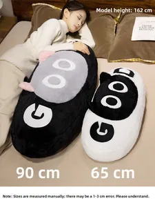 Detail of plush cat pillow with GOOD embroidery showing soft texture and size comparison