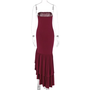 Close-up of asymmetrical ruffled fishtail hem on a burgundy bodycon dress