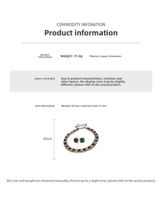 Macro detail of green rhinestone jewelry set showing dimensions and gold plated finish