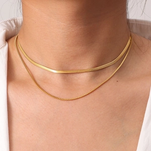 Close-up of 18K gold-plated stainless steel layered box chain and snake bone necklace