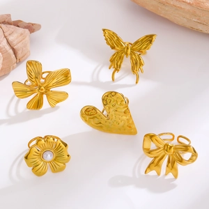 Detail of five gold rings set with bow, pearl flower, heart and butterfly patterns