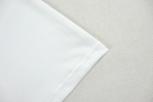 Detail shot of pure white fabric texture and precision double stitching on a slim set