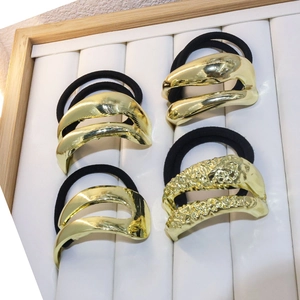 Set of 4 gold minimalist metal hair ties with smooth and hammered texture designs