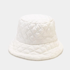 Detailed view of white quilted bucket hat featuring classic diamond lattice stitching texture