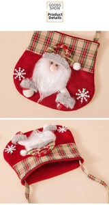 Close-up of a red felt Christmas gift bag featuring a 3D Santa doll and plaid patterns