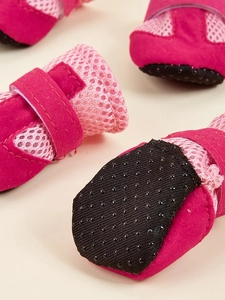 Detail of breathable mesh dog shoes with non-slip rubber soles and magic tape strap