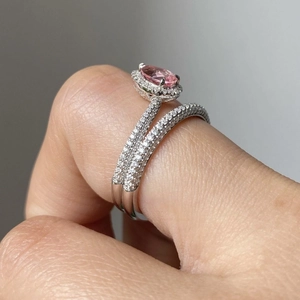 Sparkling pink oval gemstone ring set with matching diamond-encrusted silver band