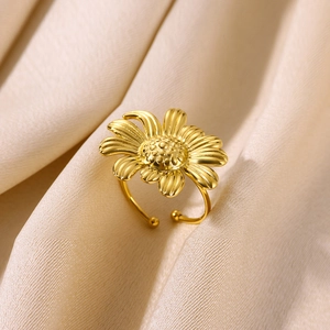 Adjustable gold plated stainless steel sunflower open ring on beige silk background