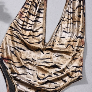 Detailed view of luxury velvet gold tiger print bodysuit with deep V-neckline