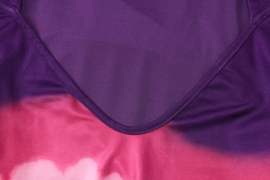 Detailed close-up of V-neckline with double-needle stitching and purple gradient print