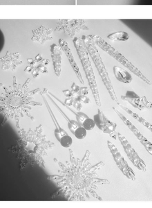 Detailed close-up of transparent snowflake and icicle crystal ornaments for Christmas decor