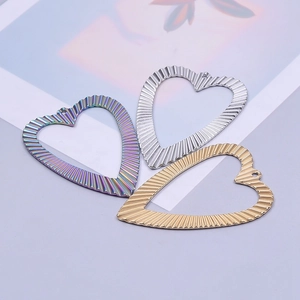 Three textured stainless steel heart pendants in rainbow, silver, and gold finish for DIY jewelry