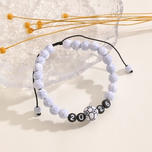 Detail of 2026 World Cup soccer bracelet with white marble beads and adjustable cord