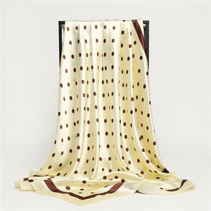 Detail of satin polka dot scarf showing smooth silk-like texture and elegant drape
