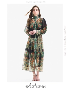 Detail of bohemian green paisley print maxi dress with lantern sleeves and floral pattern