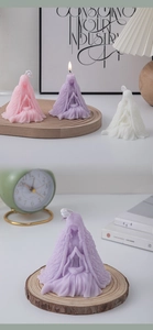 Detailed view of prayer girl scented candles in pink, purple and white wax colors