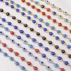 Macro view of colorful Turkish evil eye beads on gold and silver plated copper chains