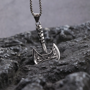 Viking style stainless steel double axe pendant on rock background, silver finish