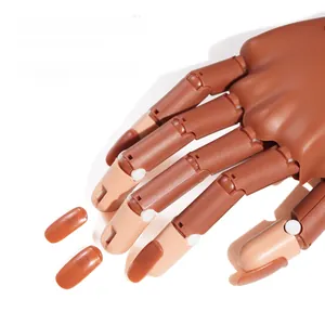 Detailed close-up showing removable nail plates on a flexible practice hand model