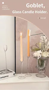 Close-up of elegant tall glass candle holders with slender stems for romantic decor
